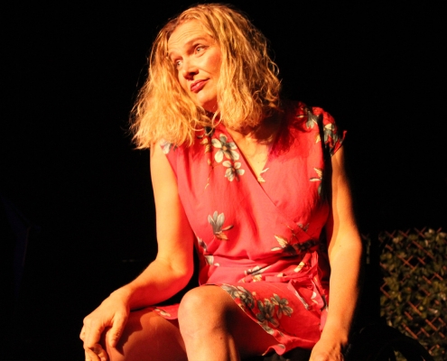 a woman sitting on stage