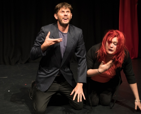 A man and woman on stage acting out anxiety