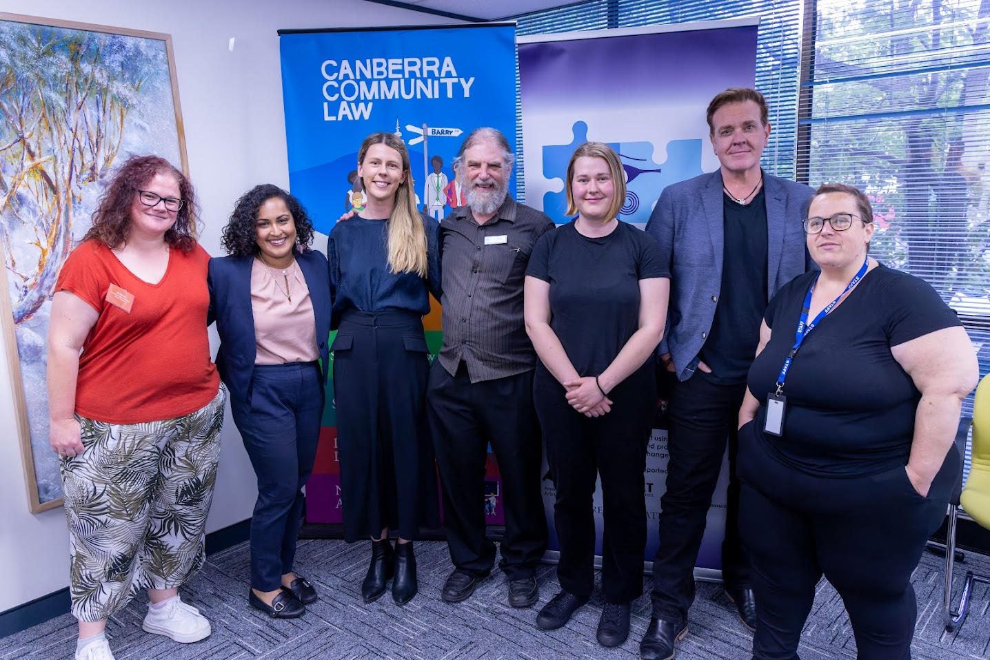 A group of men and women smile for the camera