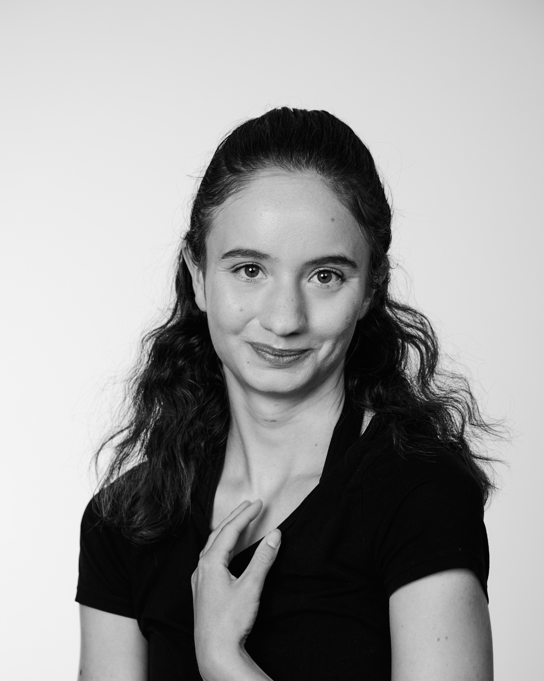 A woman in a black shirt smiling at the camera
