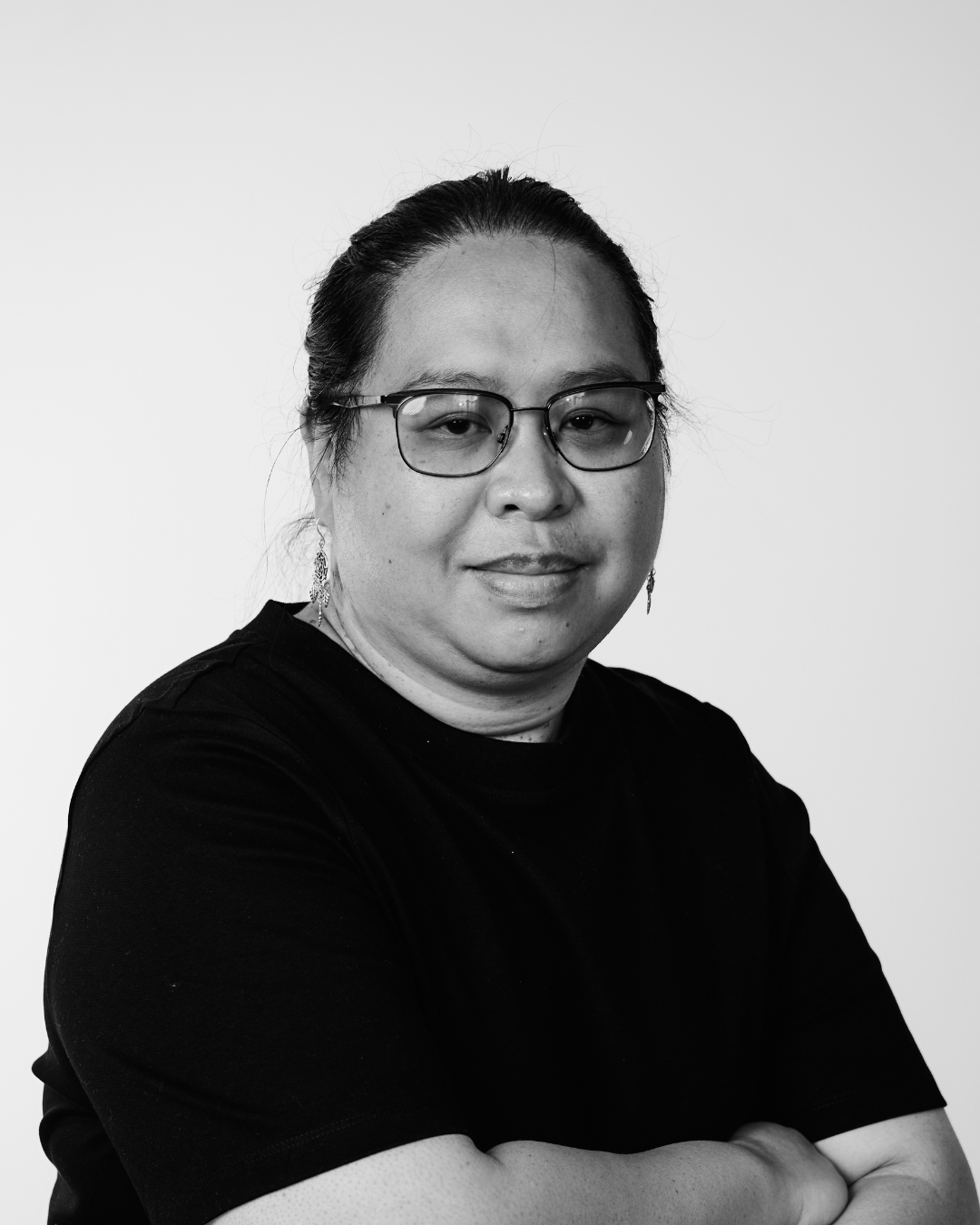 A woman in a black shirt smiling at the camera