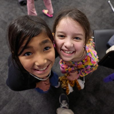 A group of children from different cultural backgrounds smile and play games