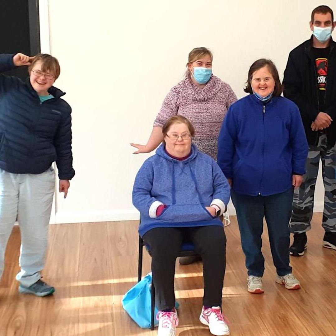 A group of men and woman smile for the camera
