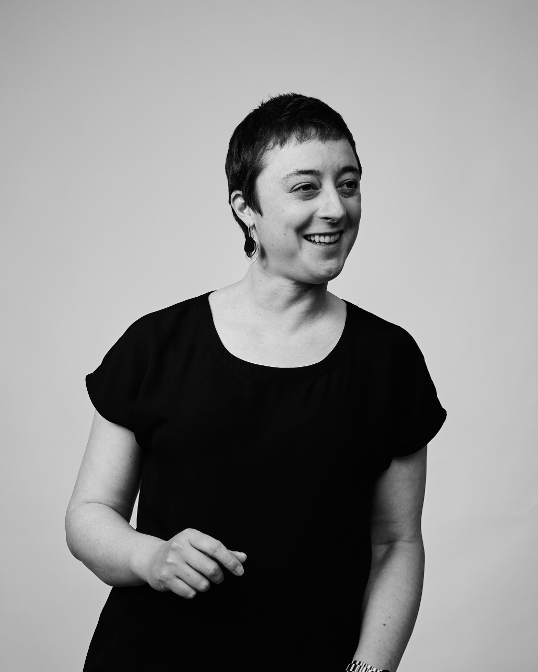 A woman in a black shirt smiling at the camera