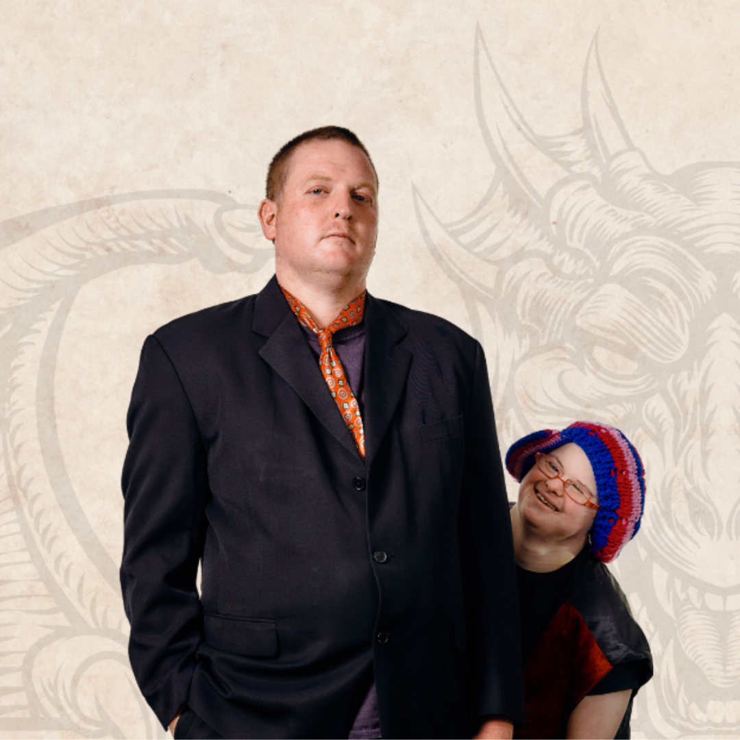 A man and a woman stand dramatic poses with a background drawing of a dragon