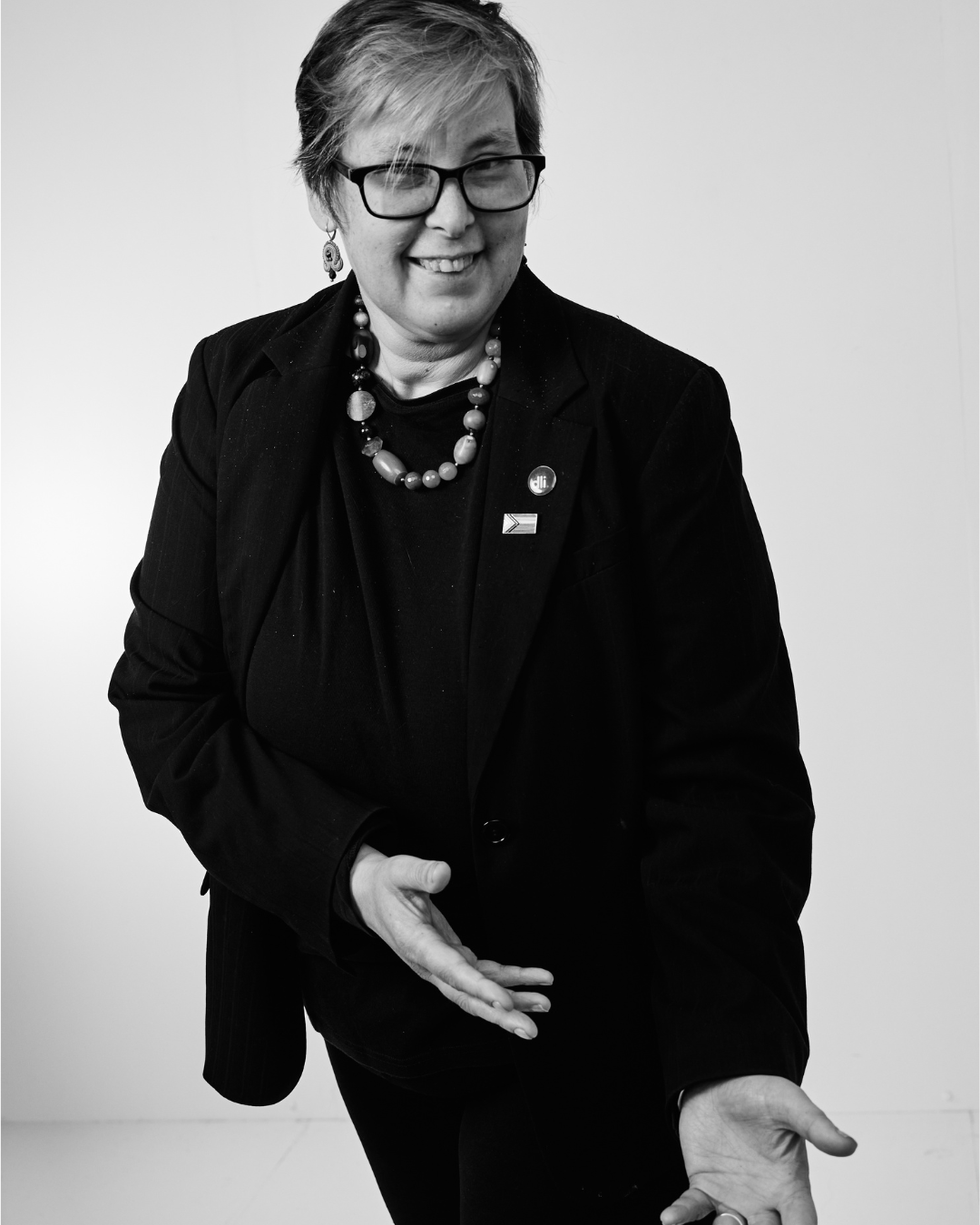 A person in a black shirt smiling at the camera